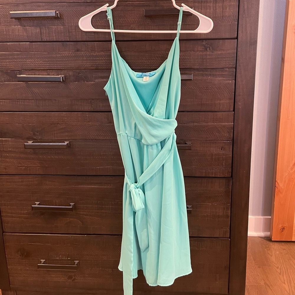 Never worn.  Beautiful aqua side zip, adjustable strap side tie detail dress.
